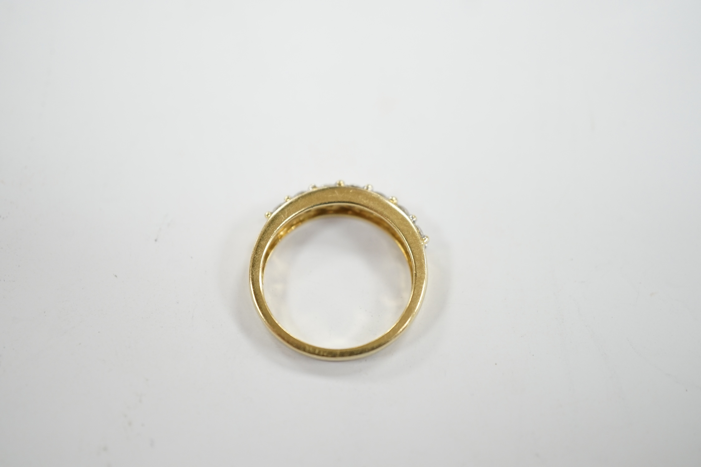 A modern 18ct gold and seven stone diamond set half hoop ring, size N, gross weight 4 grams.